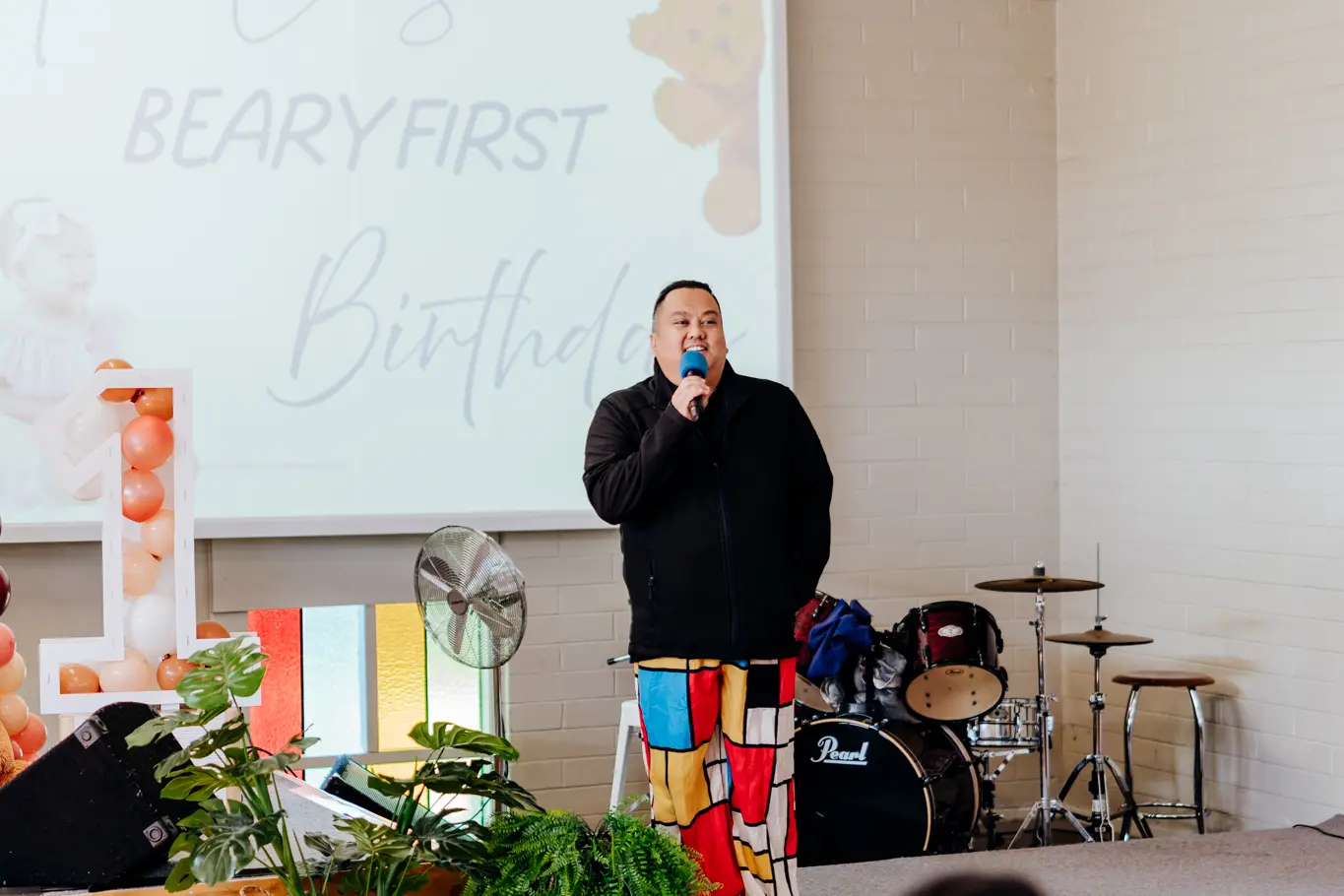 A Filipino man talking into the mic.