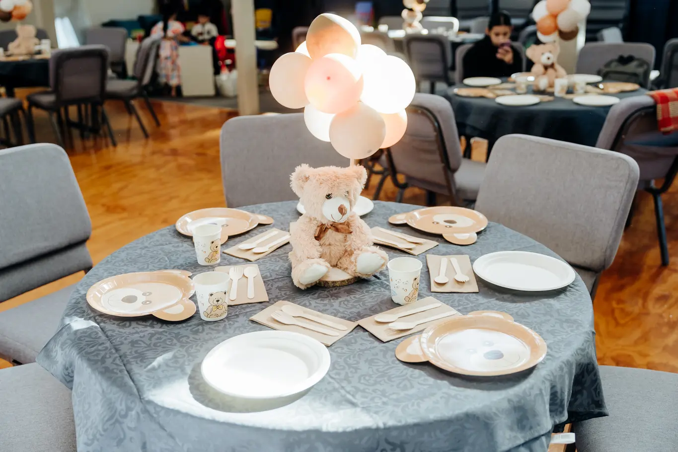 A round table with bear-themed decorative elements.