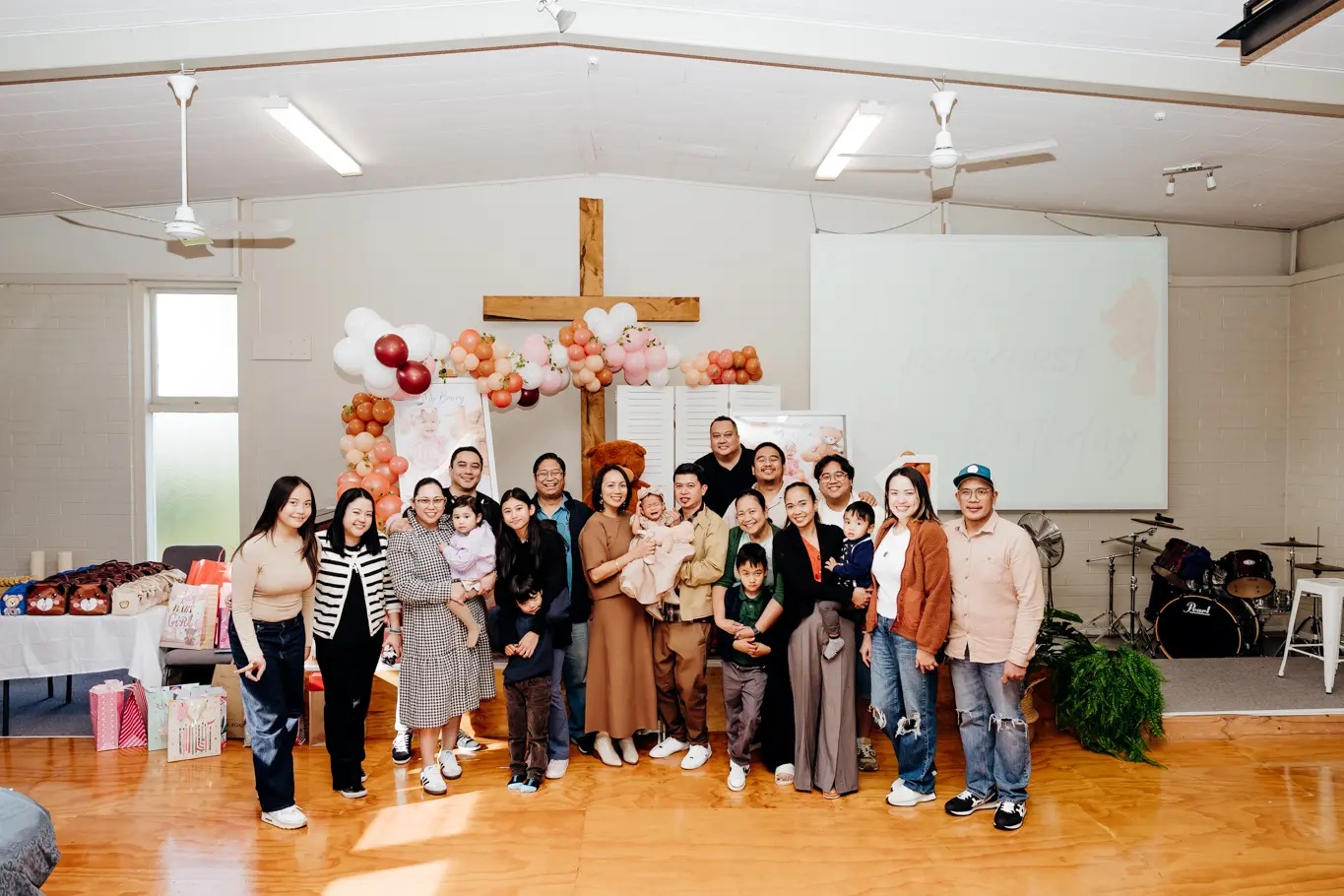 A group photo during a 1st birthday event.